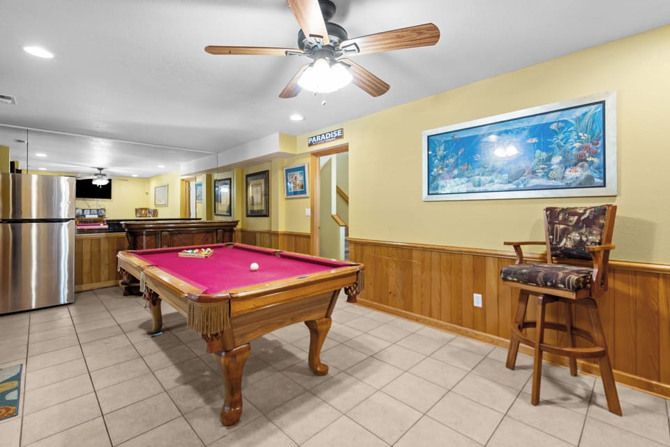Step into your own game room paradise. Rack up some fun on the full-size billiards table, unwind with a cool drink from the mini fridge, and let the tropical artwork transport you to island mode.