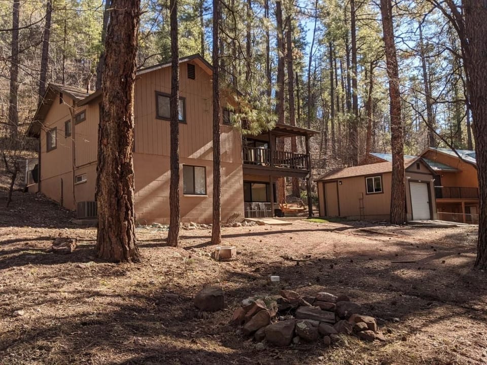 On an acre with kids playhouse, trampoline, and swing set out front.