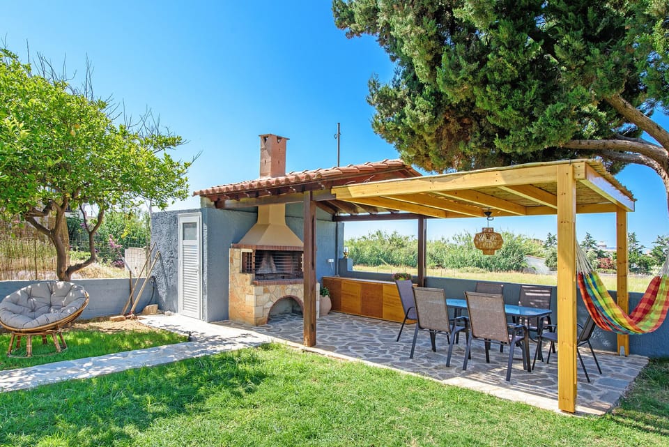 The BBQ area and the wooden pergola