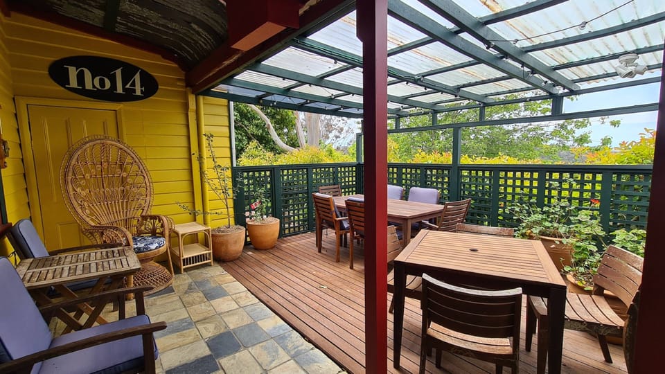 Covered deck has additional tables and chairs for dining. 
