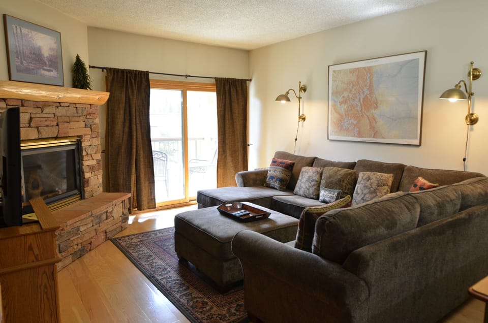 Living Room - The living room area has a comfortable sofa, cozy fireplace, and a TV.
