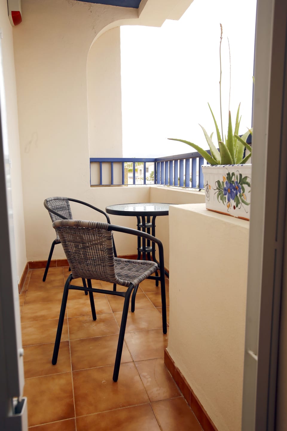 Balcony overlooking the street with views of the mountains.