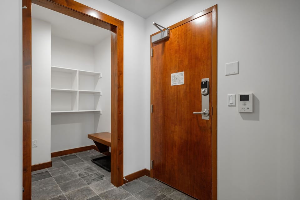 Entrance with spacious storage closet complete with ski bench and cubbies