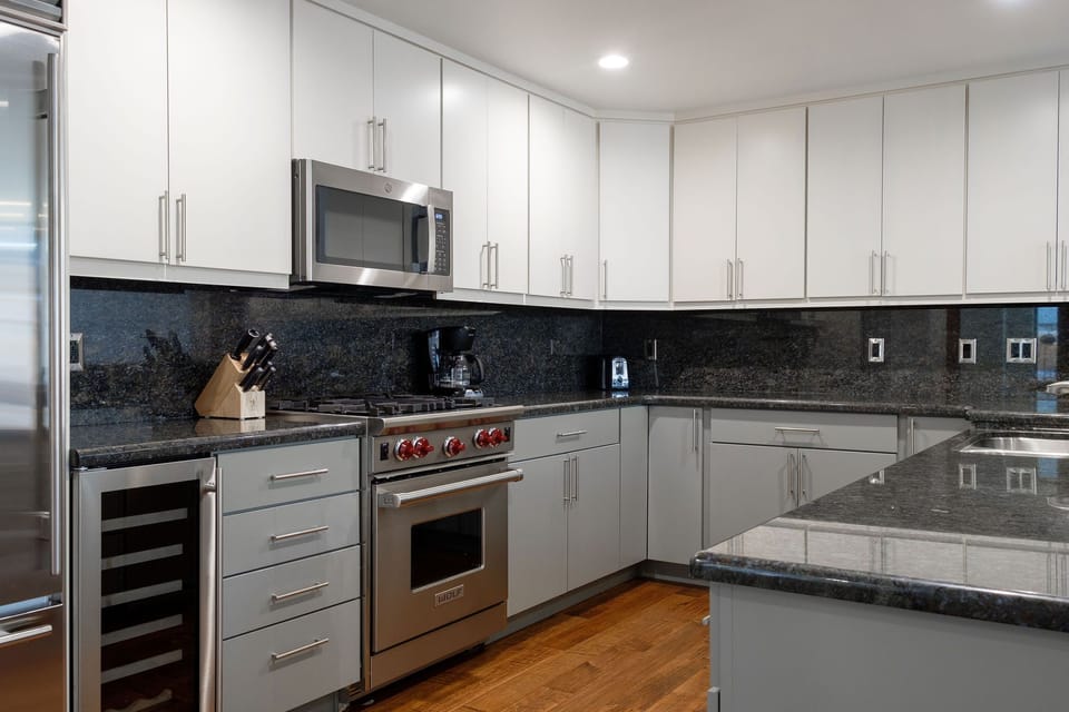 Stainless steel appliances, wolf gas range, over the range microwave, dedicated wine fridge