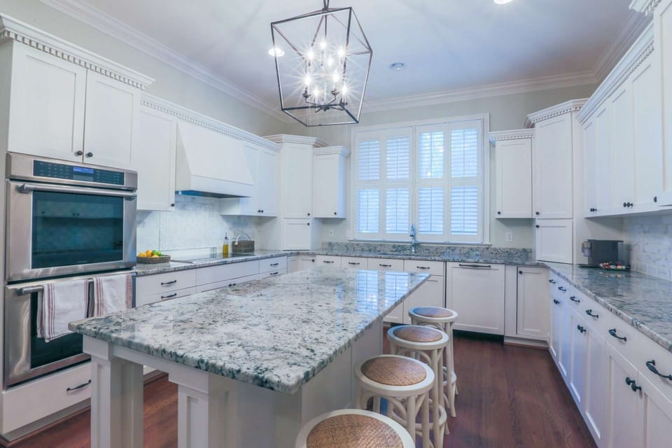 The kitchen features a double oven, cooktop, dishwasher and refrigerator.