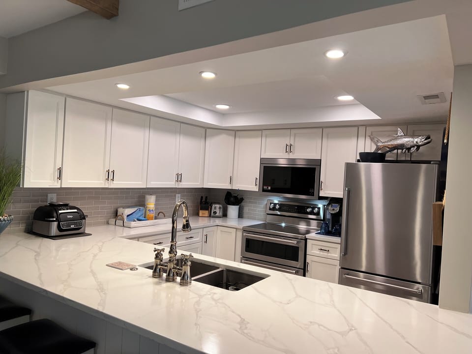 Fully stocked kitchen with Air fryer, Keurig, blender, and crock pot.
