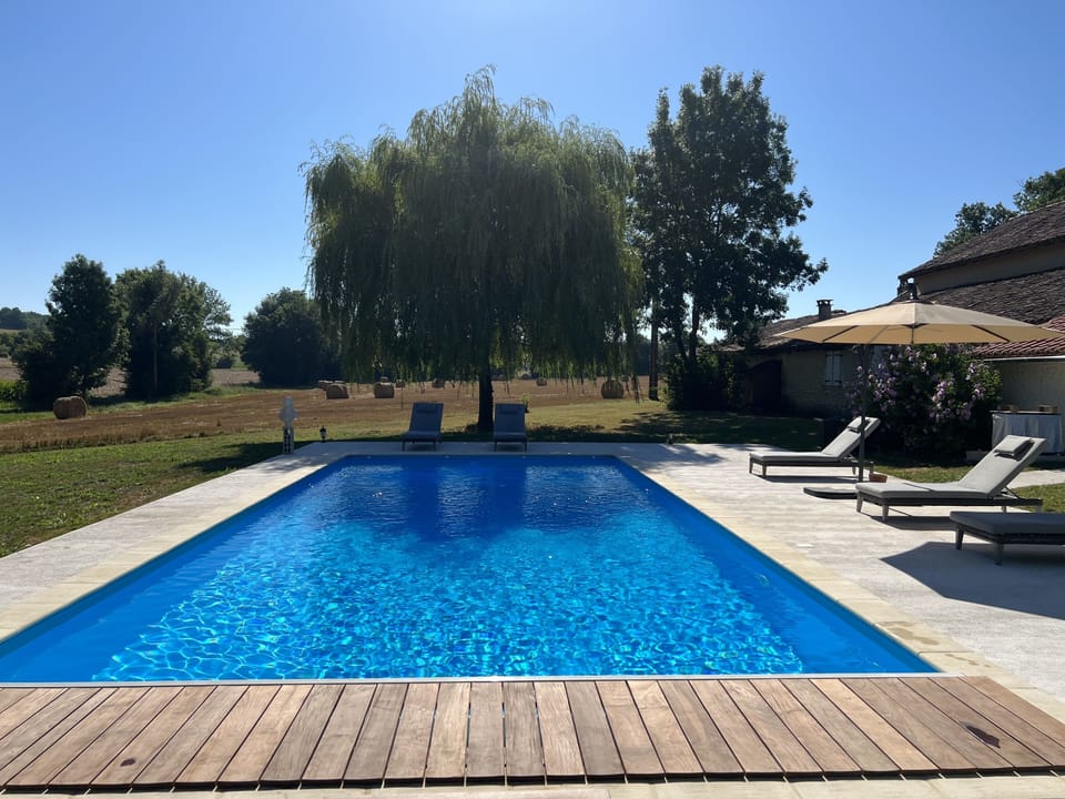 11m x 5m heated swimming pool with views to the garden and rolling hills. 