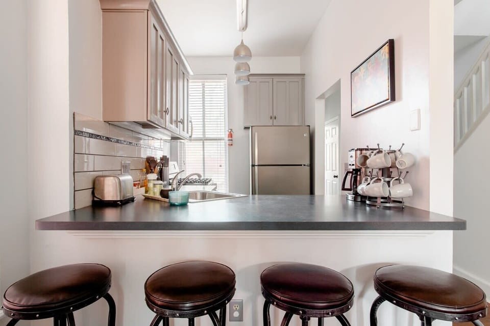 A welcoming kitchen layout with plenty of seating for meals, chats, and late-night snacks. #KitchenSpace