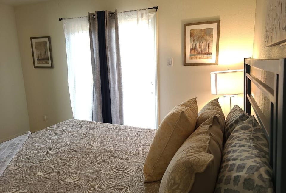 Bedroom includes a sliding glass do with access to a fenced in backyard area