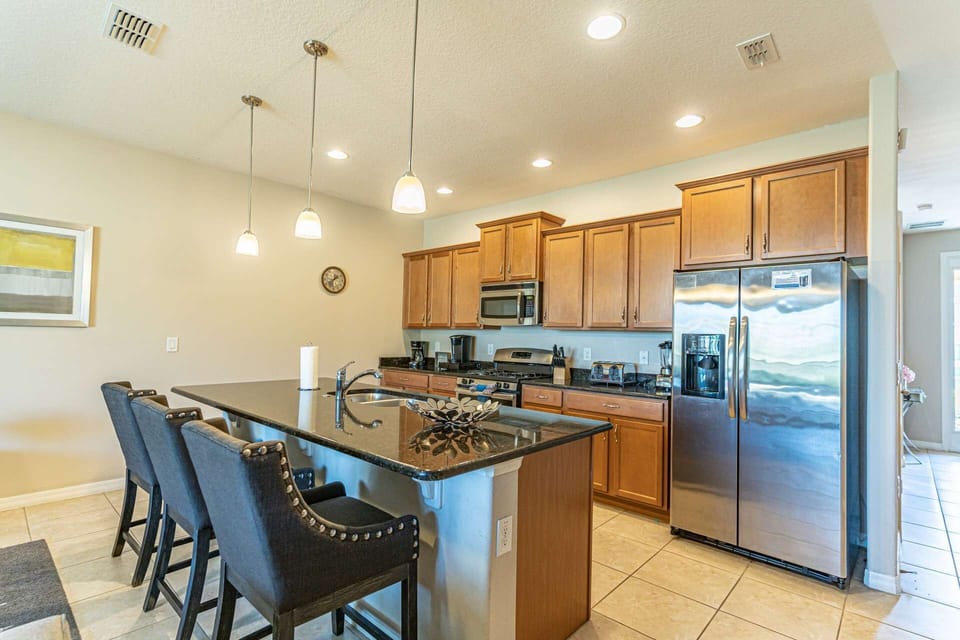 Stainless Steel Appliances and Granite Counter Tops Grace This Spacious Kitchen