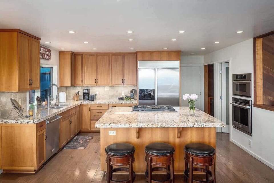 Fully stocked, spacious kitchen with gas stovetop built into the center island plus an oversized microwave and oven next to the walk-in pantry.