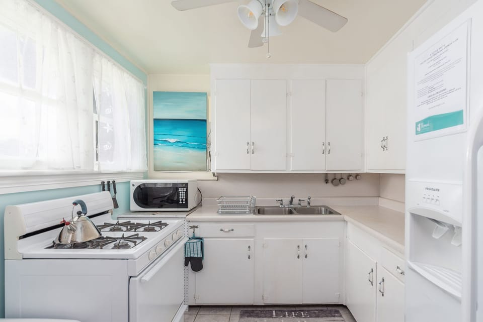 Kitchen - Full size GAS stove, microwave, refrigerator, lots of counter space. No dishwasher.