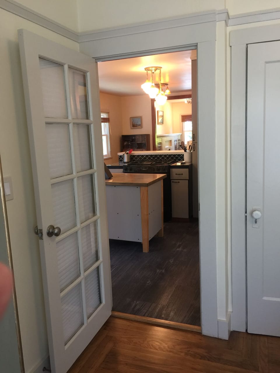 View into kitchen from queen bed in Garden Bedroom
