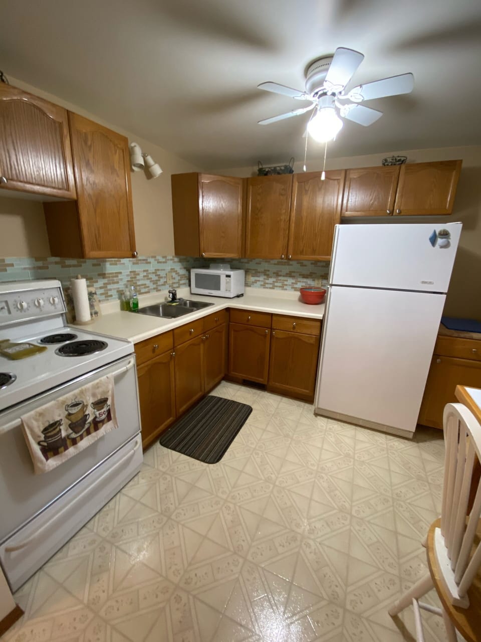 Kitchen with fridge stove microwave, and seating area