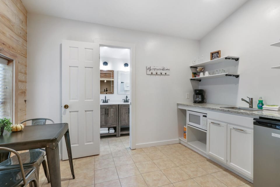 Kitchenette with a microwave, mini-fridge, coffee maker, and sink