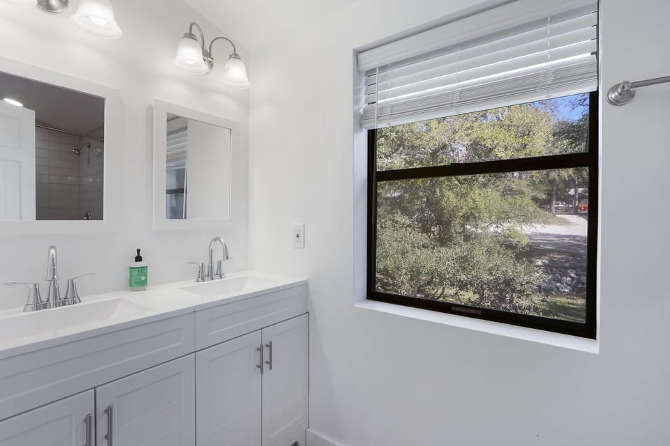 Full bathroom with dual vanities