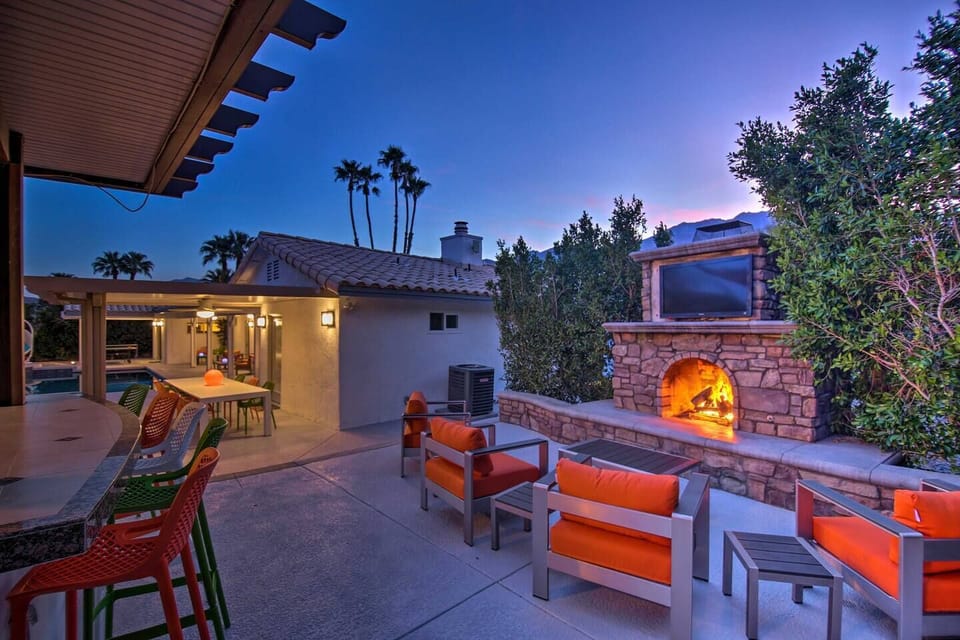 The outdoor fireplace provides a beautiful setting for evening cocktails