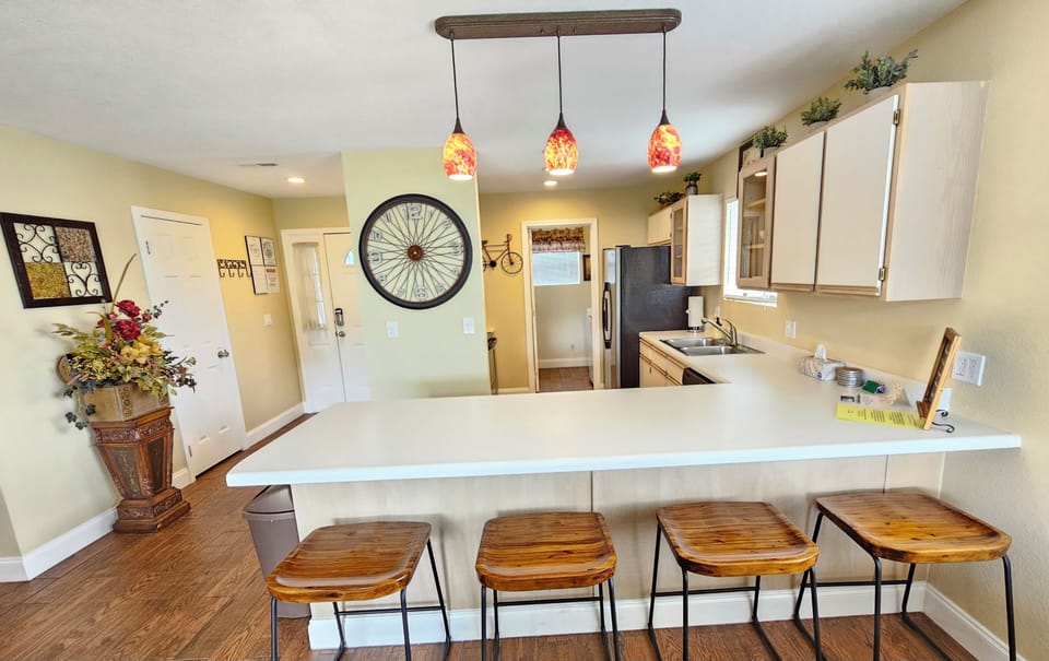 Your full-sized kitchen, breakfast bar, bar stools, and huge countertops!