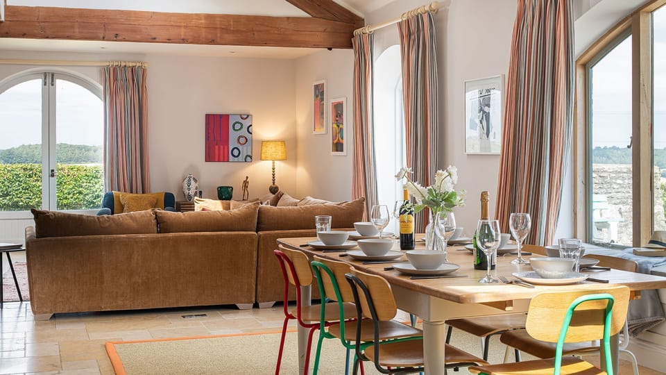 At the centre of the space sits a sleek oak dining table that extends to comfortably seat everyone.