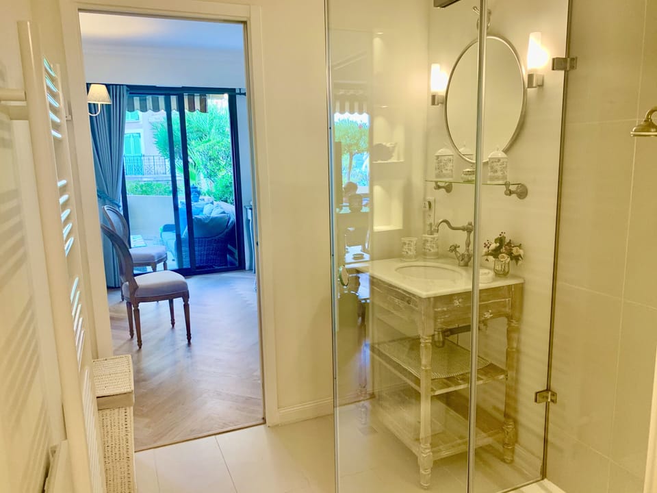Ensuite bathroom leading to the bedroom with electric towel heater.