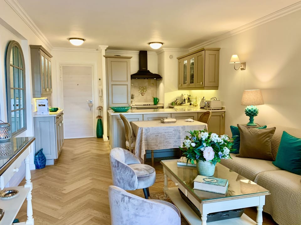 Air-conditioned living room with well- equipped open plan kitchen