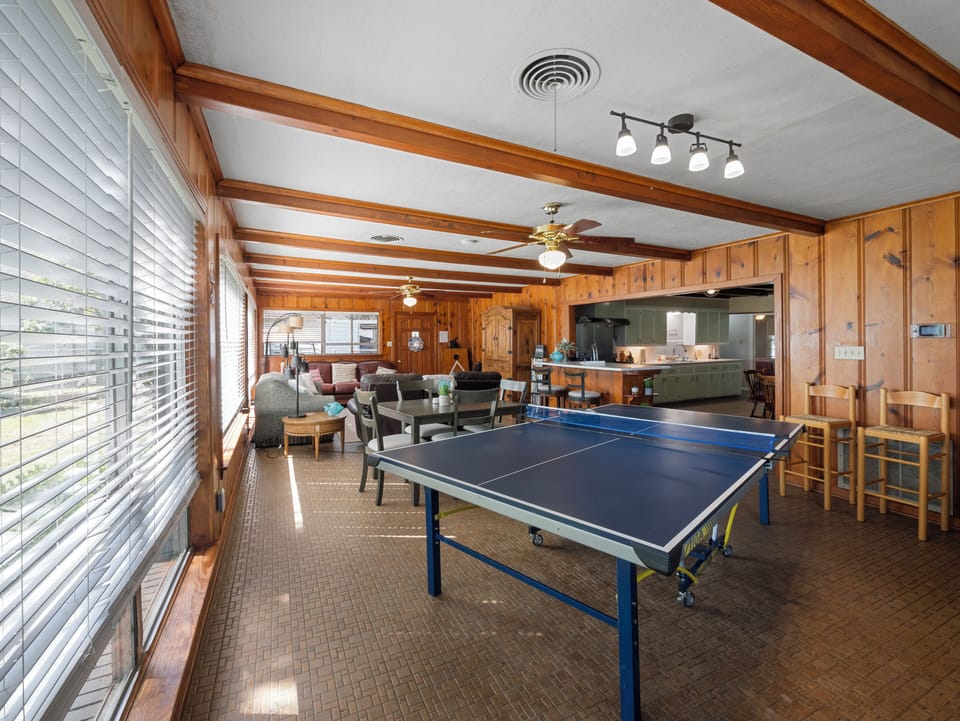 Ping-pong table & game/work table, seating area in distance.
