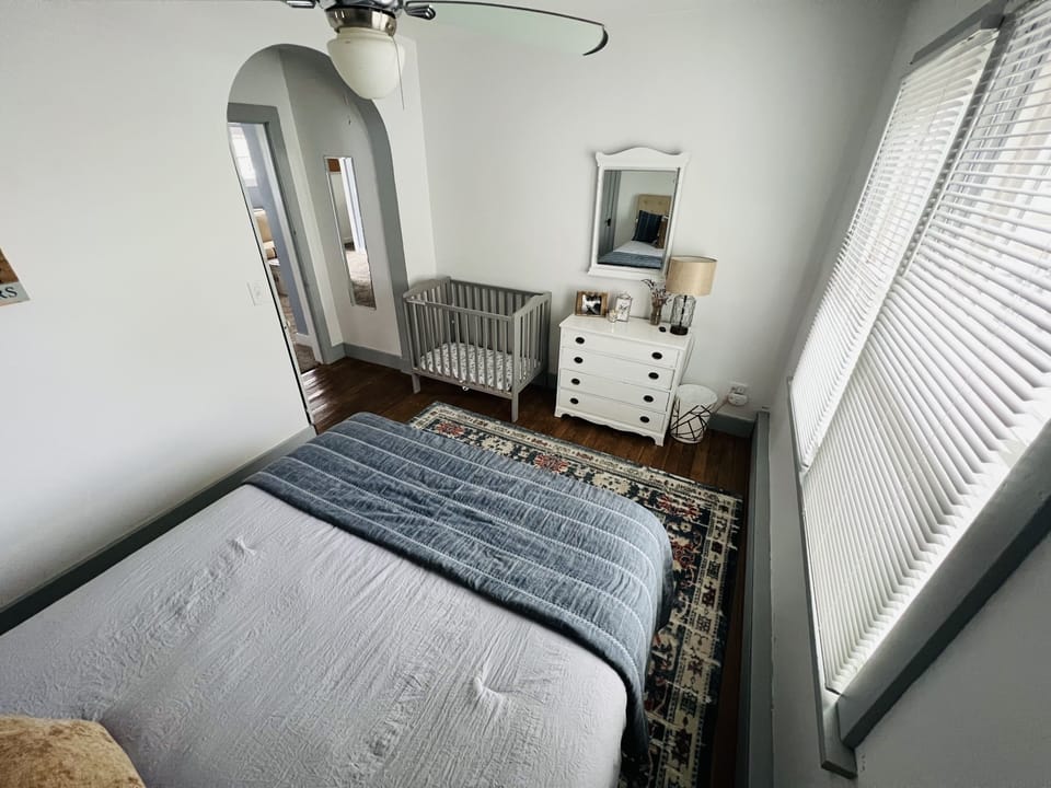 Main floor master bedroom with crib and lots of natural light 