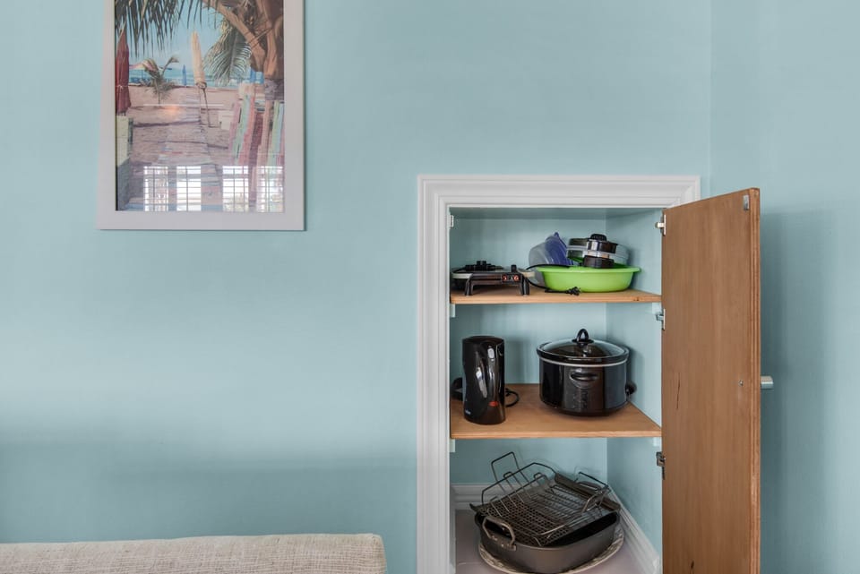 cupboard in living area for large platers, bowls, griddle, crockpot, etc.