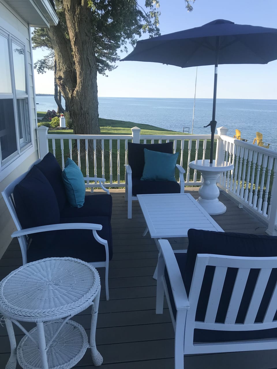 Seating area on front porch facing water 