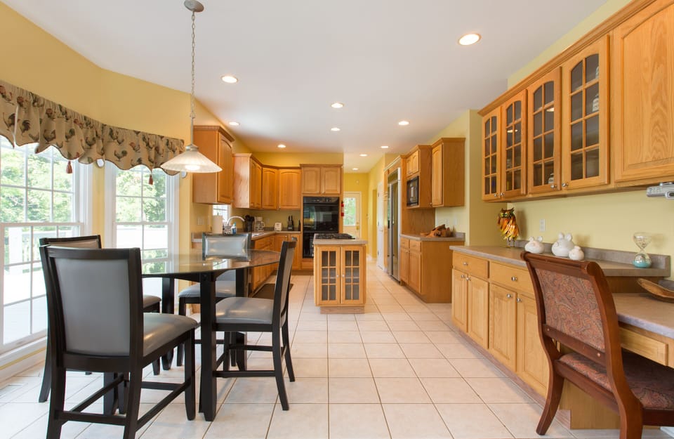 Large kitchen with plenty of pans, pots, dishes to cook. 