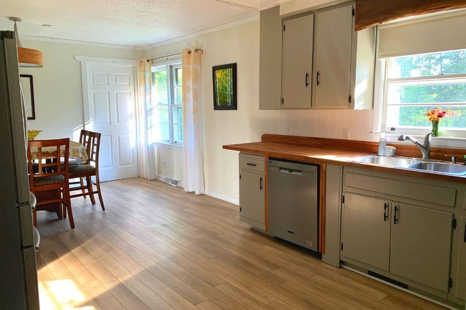 The Kitchen has stainless steel refrigerator, dishwasher and electric range