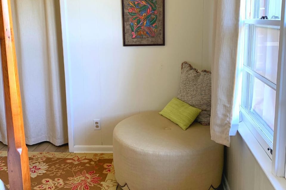 The Fields Room has large ottoman near foot of the bed