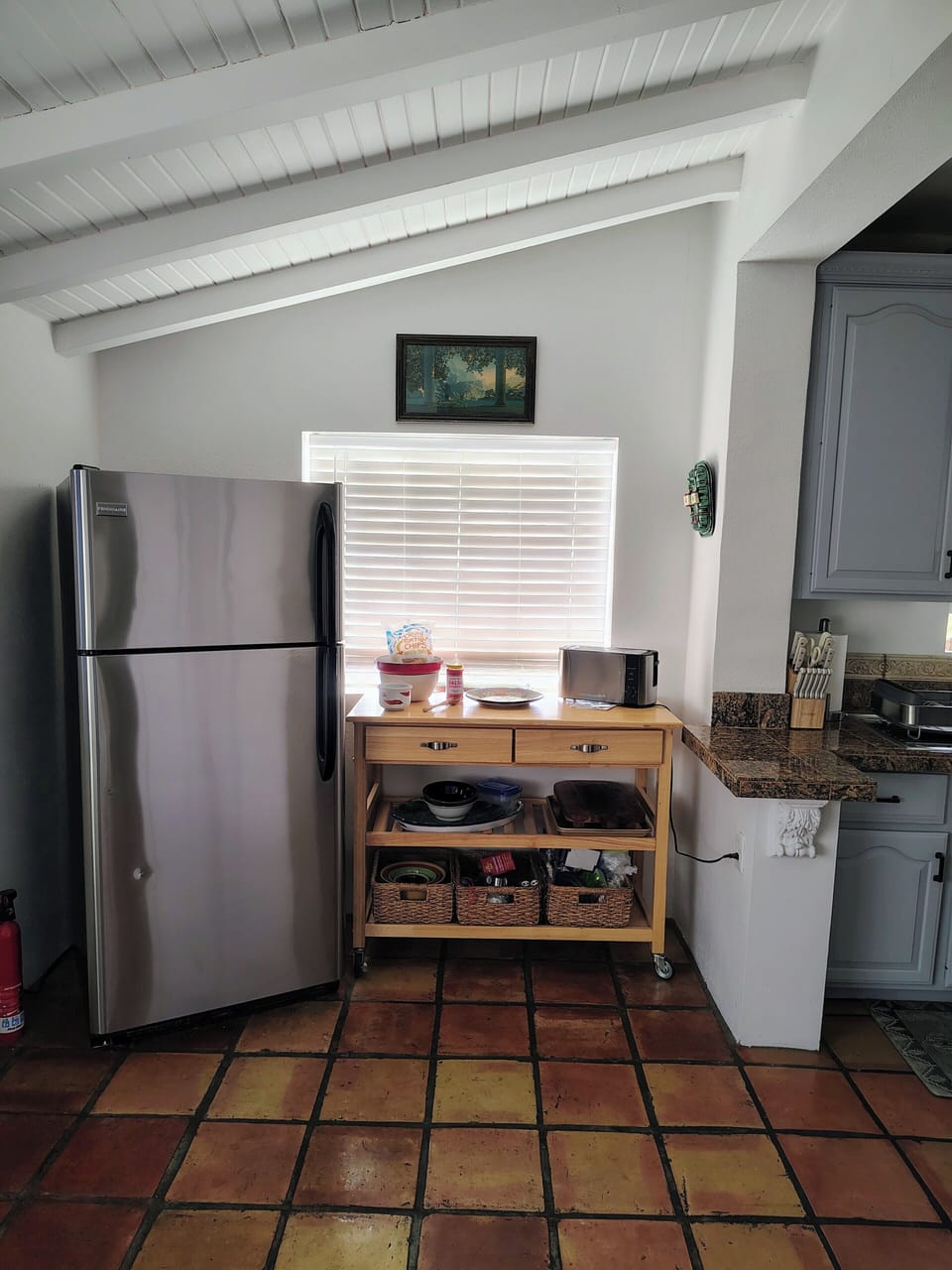 Kitchen with snacks, beverages and coffee station, with full-size refrigerator