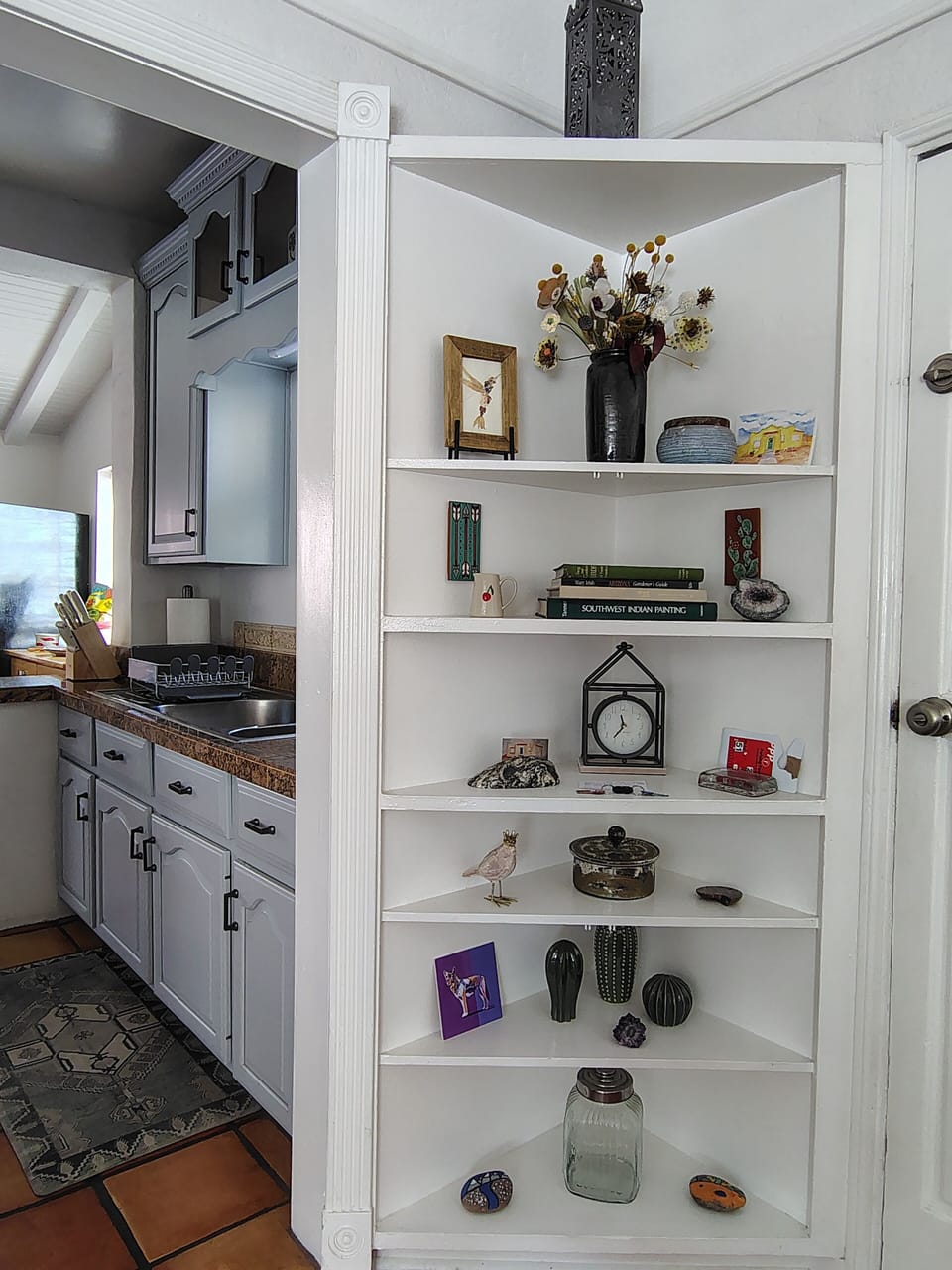 Key pickup on the shelf with view of the kitchen