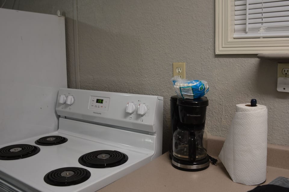 Coffee maker provided as well as a variety of pots, pans dishes and silverware.