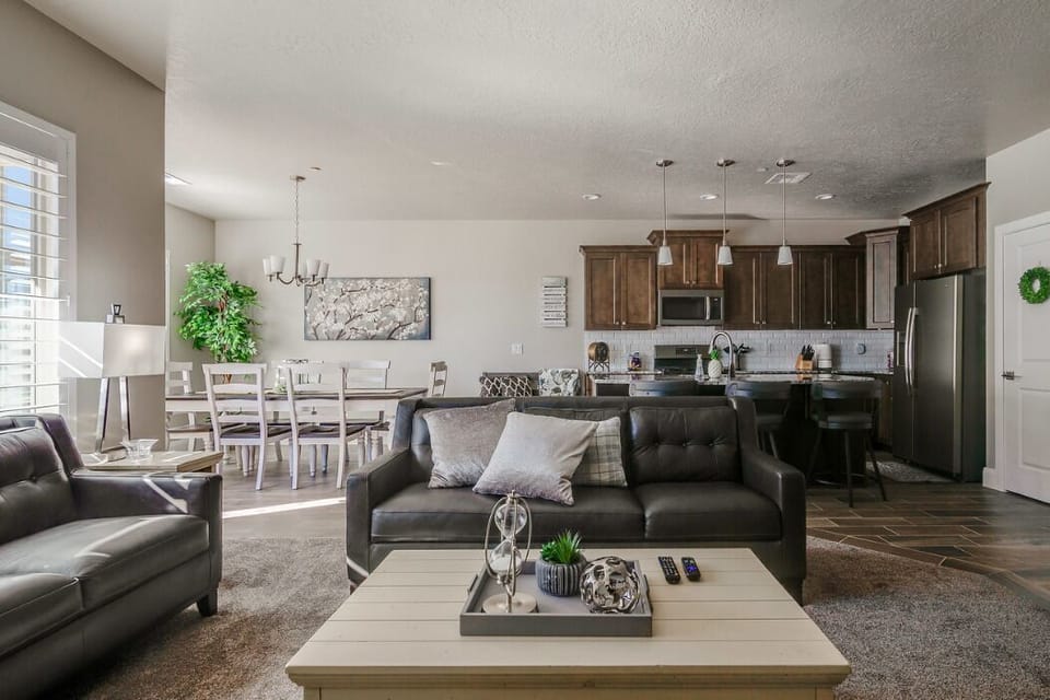 Roomy great room with well equipped kitchen, dining space, sofas and large TV.