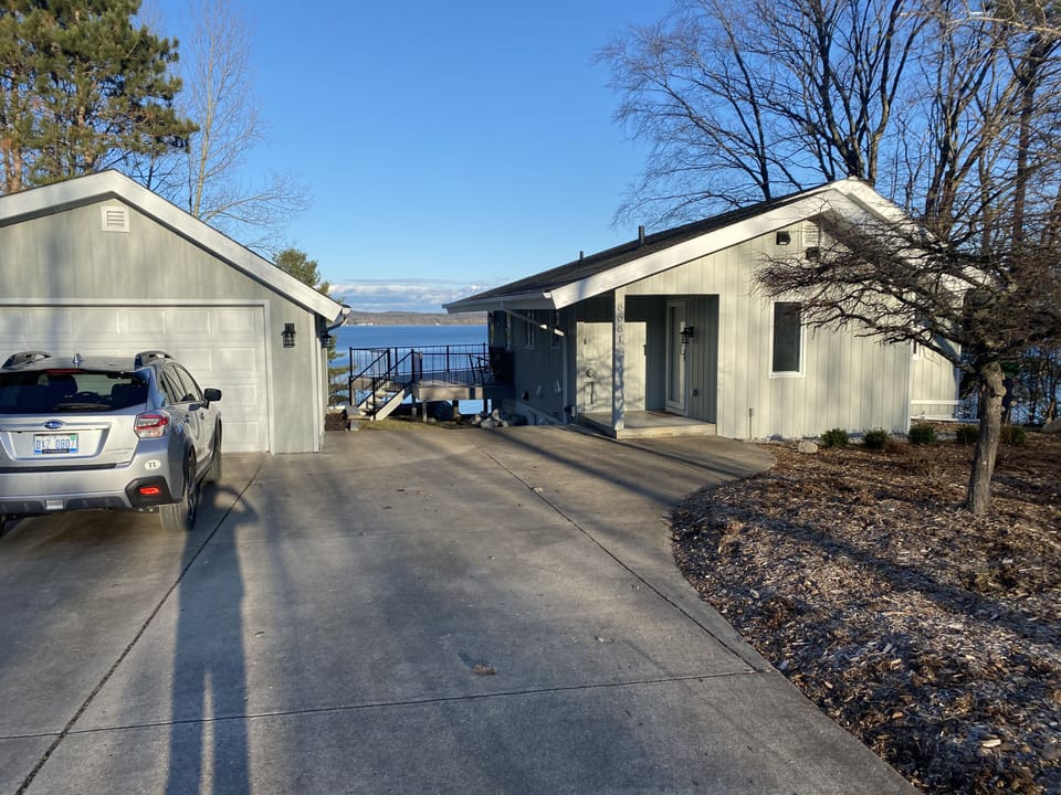 Private paradise on Torch Lake.  View of driveway and garage. 
