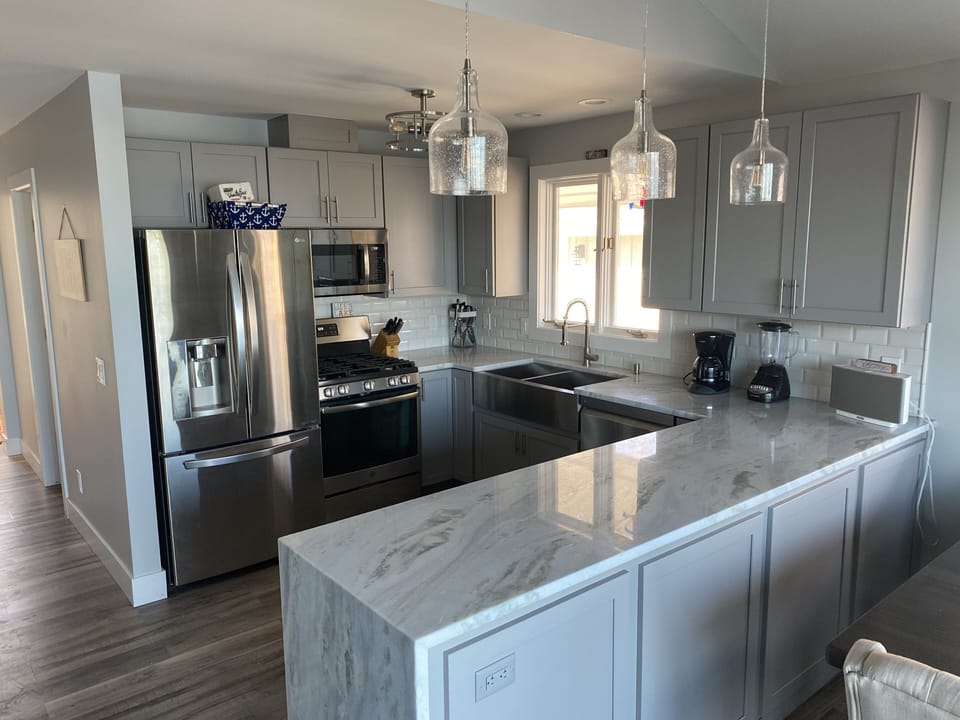Kitchen includes a waterfall granite countertop