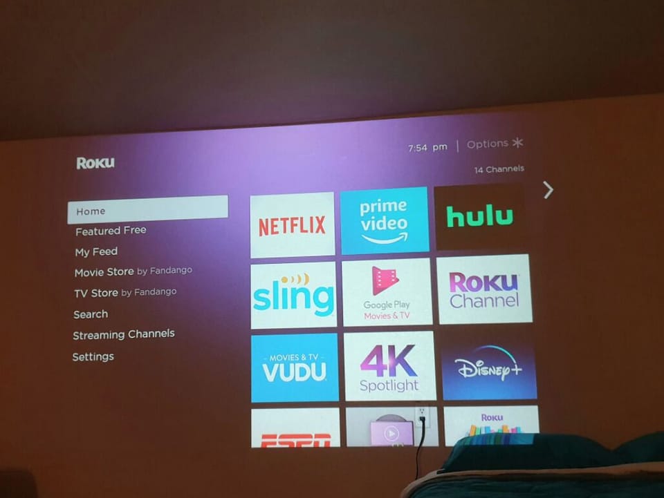 Sit back and enjoy Roku Tv on the wall projector