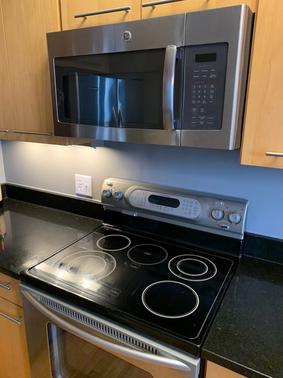Full kitchen with stainless steel stove, oven and microwave