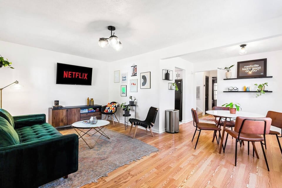 Welcome to Nashville! Experience the city like a local in this beautifully designed Duplex. Featured is the front unit living room dining/living space. Don't forget we have some Netflix for you! Enjoy your stay!