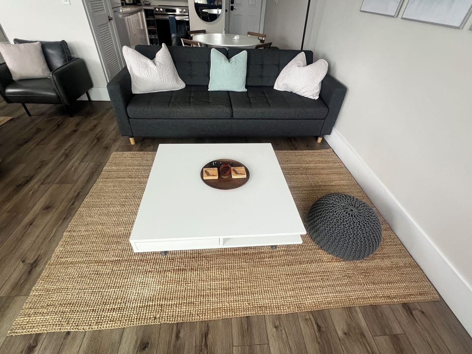 Living room couch also folds out to a bed with linens in drawer below