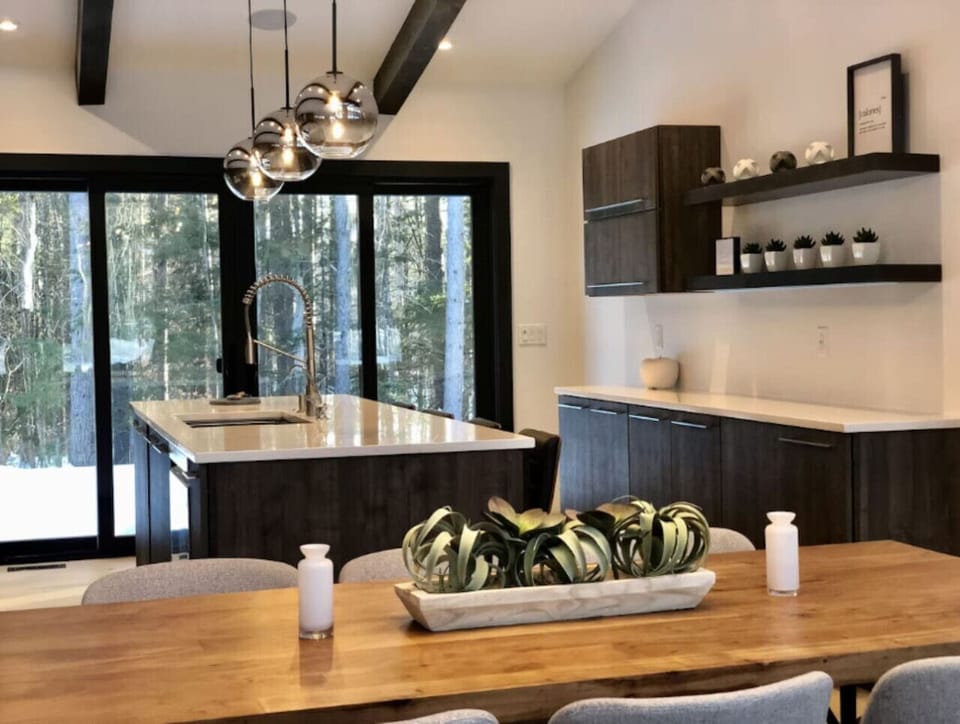 Large kitchen island and dining room table offer plenty of seating for breakfast, lunch, and dinner.
