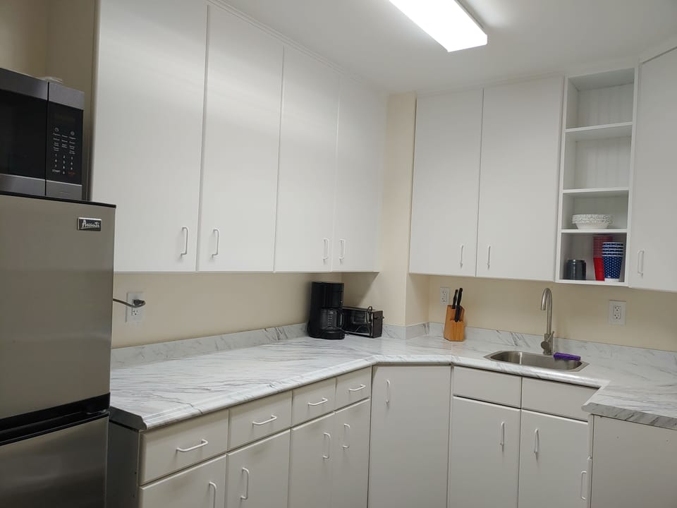 Kitchen with microwave hotplate fridge coffee pot