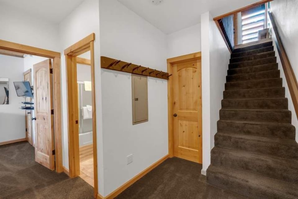 Stairs to upper level, shared tub/shower bathroom