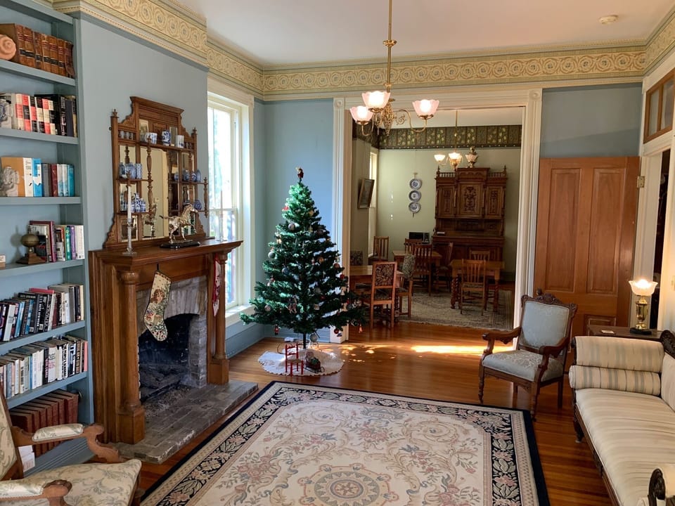 View of parlor/living room looking through doorway into dining room