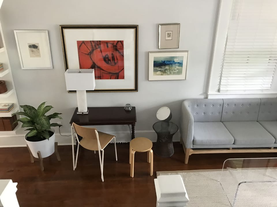 Living room with small office area next to sofa.
