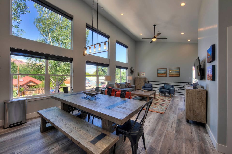 Large dining table next to living area and kitchen