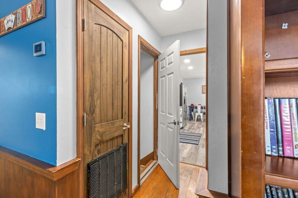 Hall to full bath, kitchen, dining, & laundry. Stairs to bottom floor on left.