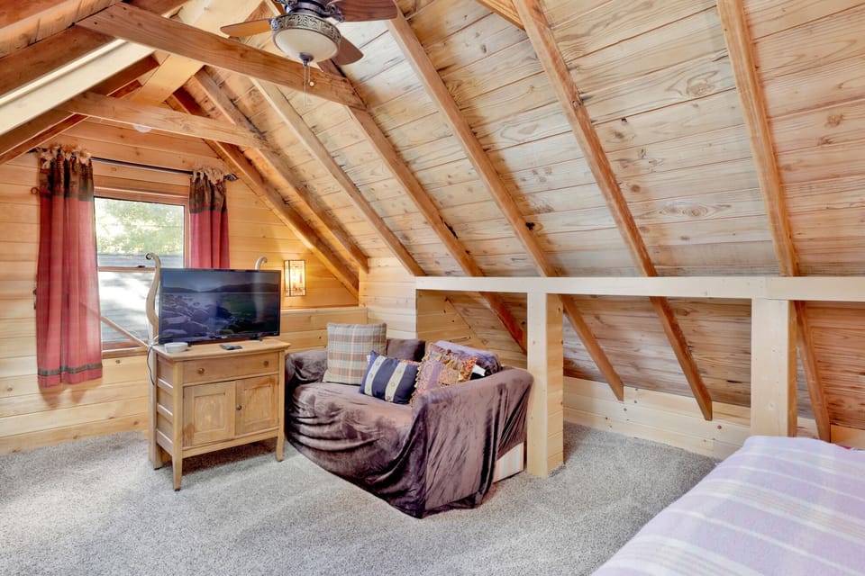 Peaceful cabin bedroom with plush bedding, and beautiful views—ideal for restful nights, cozy mornings, and a relaxing mountain escape.